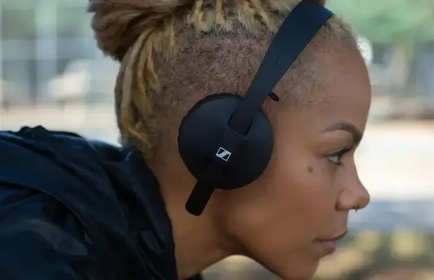 A woman listening to music on Sennheiser headphones